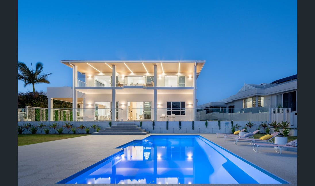 Resort-style pool with LED lighting at twilight
