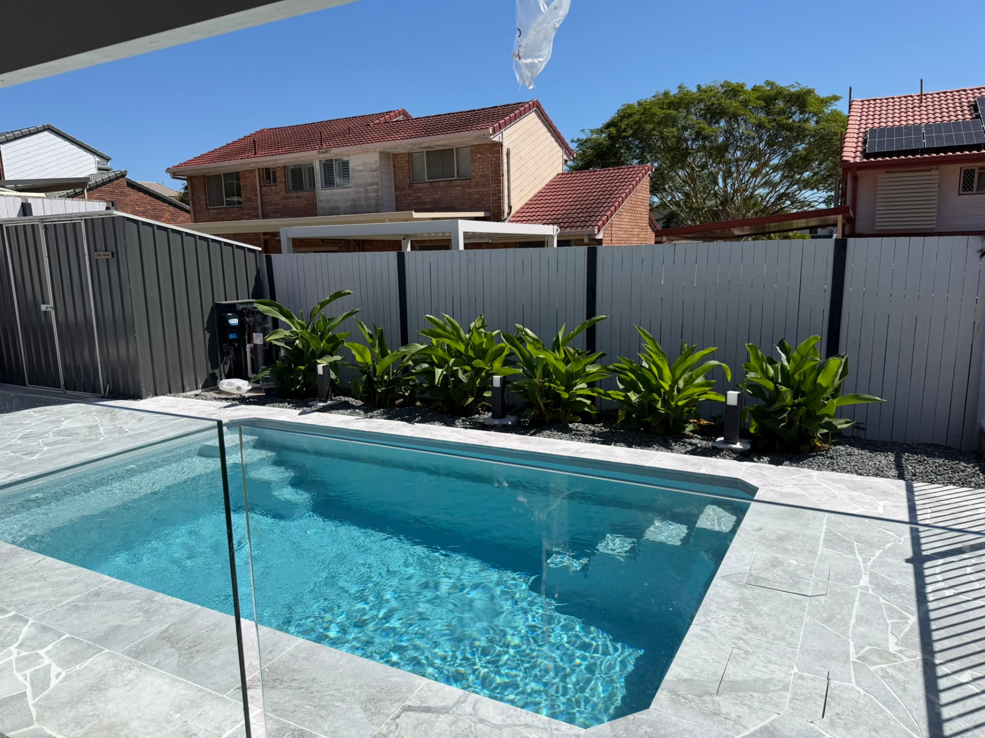 Crystal clear fibreglass pool with tropical landscaping